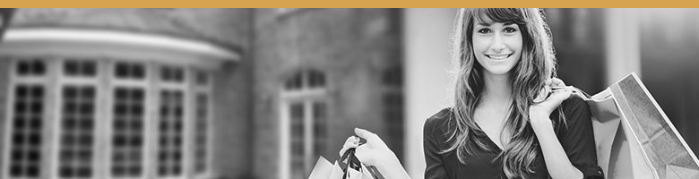 Black and white image of a brand stakeholder, a customer. Woman with shopping bags.