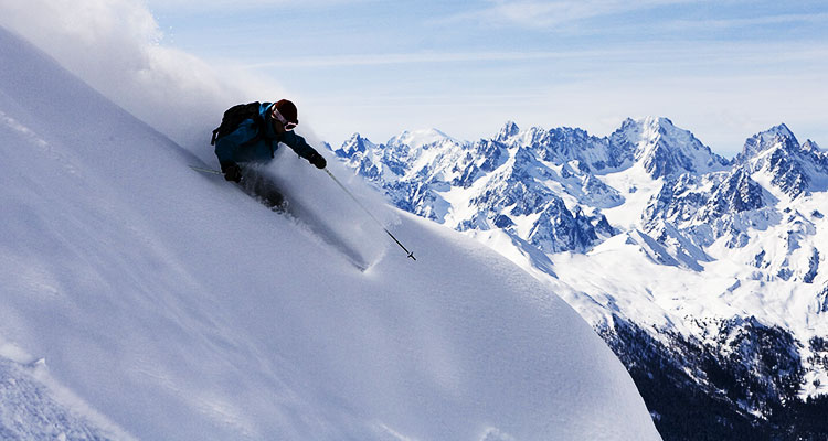 A skier coming down a mountain in fresh powder