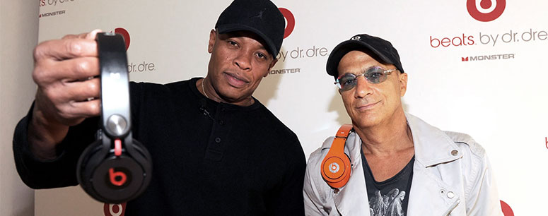 Beats founders Dr. Dre and Jimmy Iovine holding their product