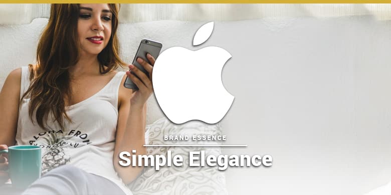 Apple's brand essence is simple elegance. Woman using an iPhone on the couch.