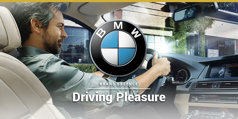 BMWs brand essence is driving pleasure. Man Driving BMW.