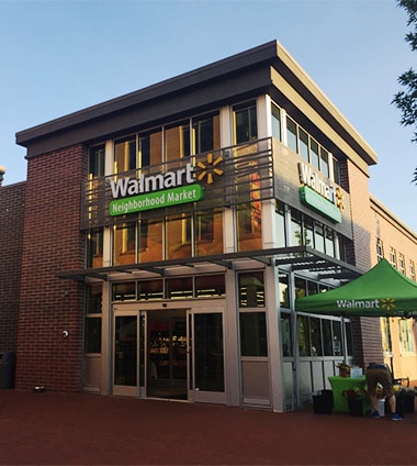 Outside Walmart Neighborhood Market on a sunny day.