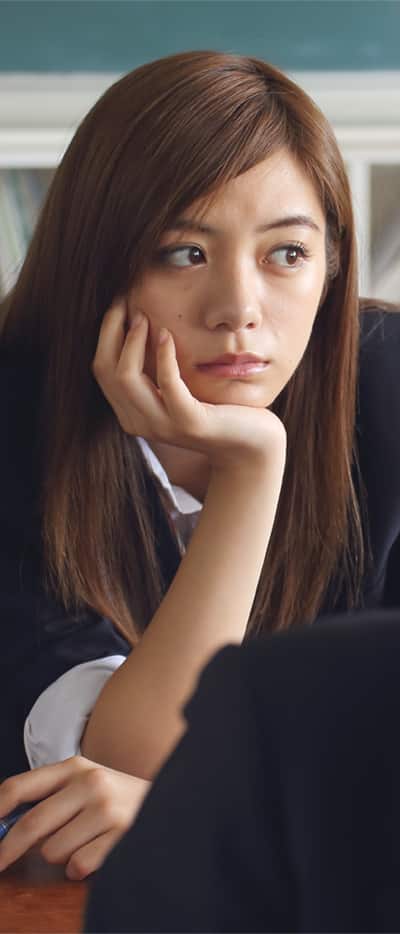 Asian woman distracted in class