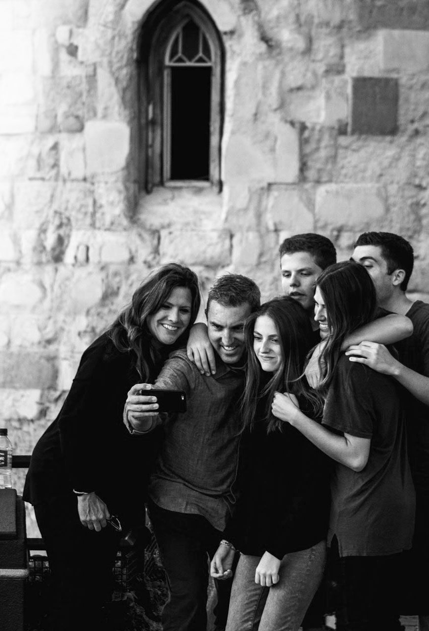 Group of friends taking a selfie in front of a castle parapet