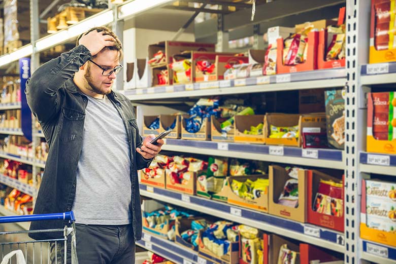 Young man confused with assortment of the store.