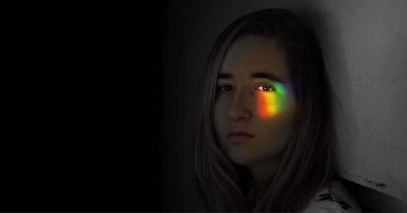 Woman with a rainbow cast over her eye. Best color combinations for logos 2020