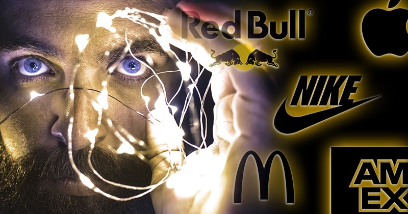 Mentalist performing an illusion. Logos of Red Bull, Nike, McDonald's, American Express, and Apple.